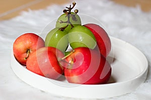 Apple strawberry and green grapes on white background