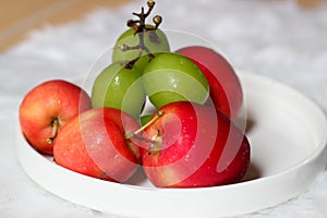 Apple strawberry and green grapes on white background