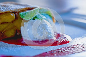 Apple strudel with cinnamon, powdered sugar and vanilla ice cream photo