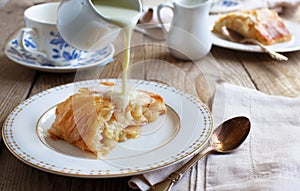 Apple strudel with cream sause. Selective focus