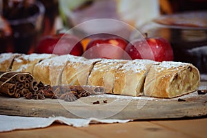 Apple strudel with fresh apples, anason and cinnamon on a wooden board