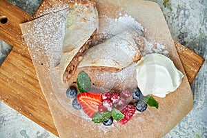 Apple strudel. Gray textured background. Beautiful serving dishes. Dessert. Food chain