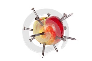 Apple stuck with lots of iron nails isolated