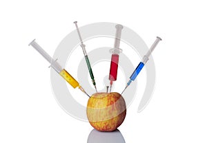 Apple with a syringe filled with chemicals.