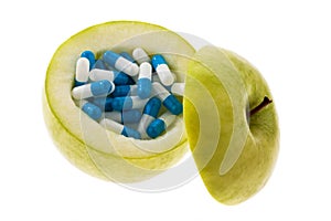 Apple with tablets capsules.