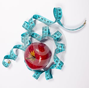 Apple and tape measure, diet concept