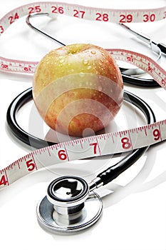 Apple, tape measure and stethoscope