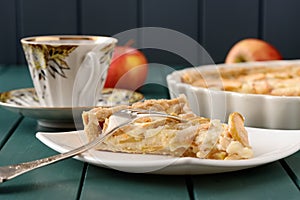 Apple tart with cup of tea and three whole apples