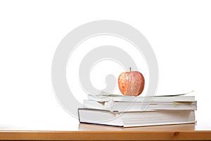 An apple on top of a stack of books