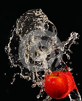 Apple under running water.