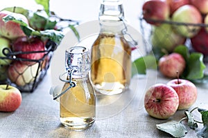 Apple vinegar. Bottle of apple organic vinegar or cider on wooden background. Healthy organic food