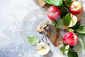 Apple vinegar. Healthy organic food. A bottle of apple cider vinegar on a light stone countertop.