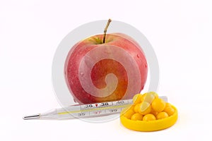 Apple vitamins and thermometer