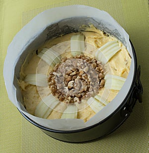 Apple and Walnut Cake Mixture in Paper Lined Baking Pan.