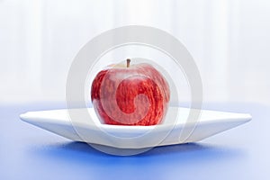 Apple in white plate