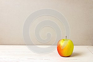 Apple on white wooden table