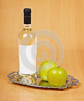 Apple wine in closed bottle on tray