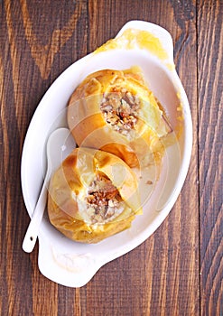 Apples baked with honey and nuts in a white plate