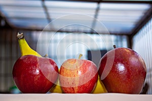 Apples with banana close up photo