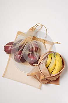 Apples and bananas in reusable bags