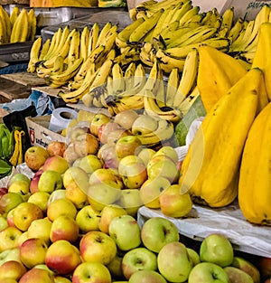 Apples, bananas and star fruit in an indoor market in Cuenca, Ecuador