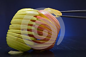 Apples being grasped by chopsticks
