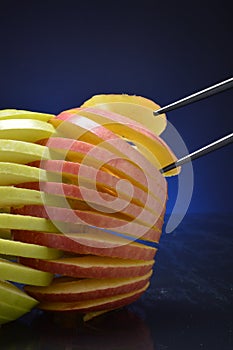 Apples being grasped by chopsticks