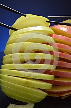 Apples being grasped by chopsticks
