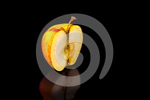 Apples on black wavy mirror.