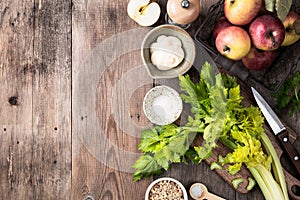 Apples, celery, lime, walnut and mayonnaise on a wooden background