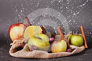 apples and cinnamon on a coarse cloth yellow leaves