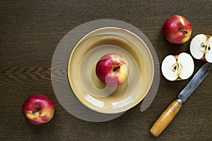Apples in a clay dish on wooden board