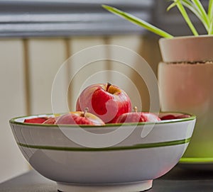 Apples in a fruit bowl.