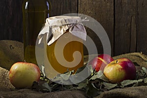 Apples with a jar of honey and a bottle of olive oil