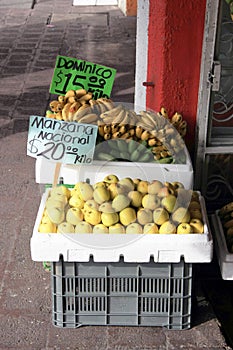 Apples [Manzana] & Bananas [Dominico] in crates outside shop