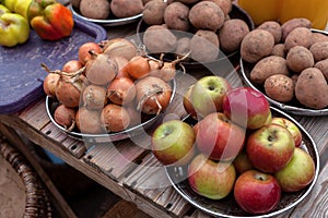 Apples, onions, potatoes, peppers. A vegetable counter at a street market. Trade in seasonal goods