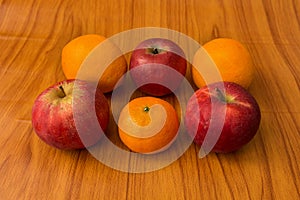 Apples and Oranges on brown background