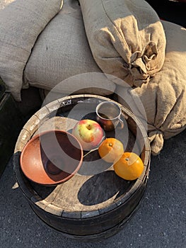 Apples and oranges on a wooden barrel