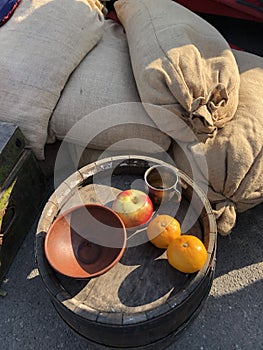 Apples and oranges on a wooden barrel