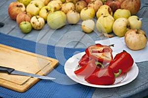 apples and pepper on a garden table