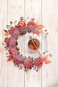 Apples, pink flowers and honey with copy space form a floral de