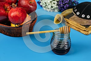 Apples, pomegranate and honey for Rosh Hashanah torah book, kippah a yamolka