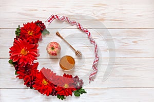 Apples, red dahlia flowers, red rowanberries and honey with copy space.  Concept for Rosh Hashanah the Jewish New Year. Top view,