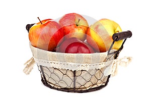 Apples in a rustic basket isolated on white