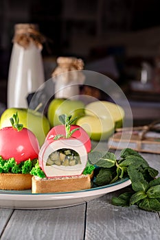 Apples shaped mousse dessert with fruit compote on shortbread tartlets