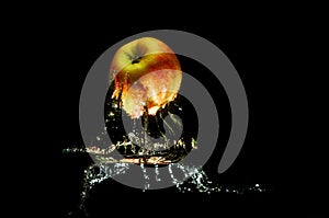 Apples in water with reflrction and splash