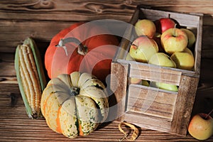 Apples in a wooden box, corn, healthy food, vegetables.