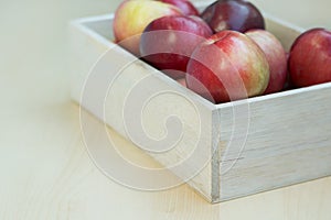 Apples in the wooden box on the table