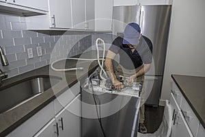 Appliance repairman working on a dishwasher