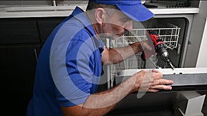 Appliance Technician Repairing a Dishwasher